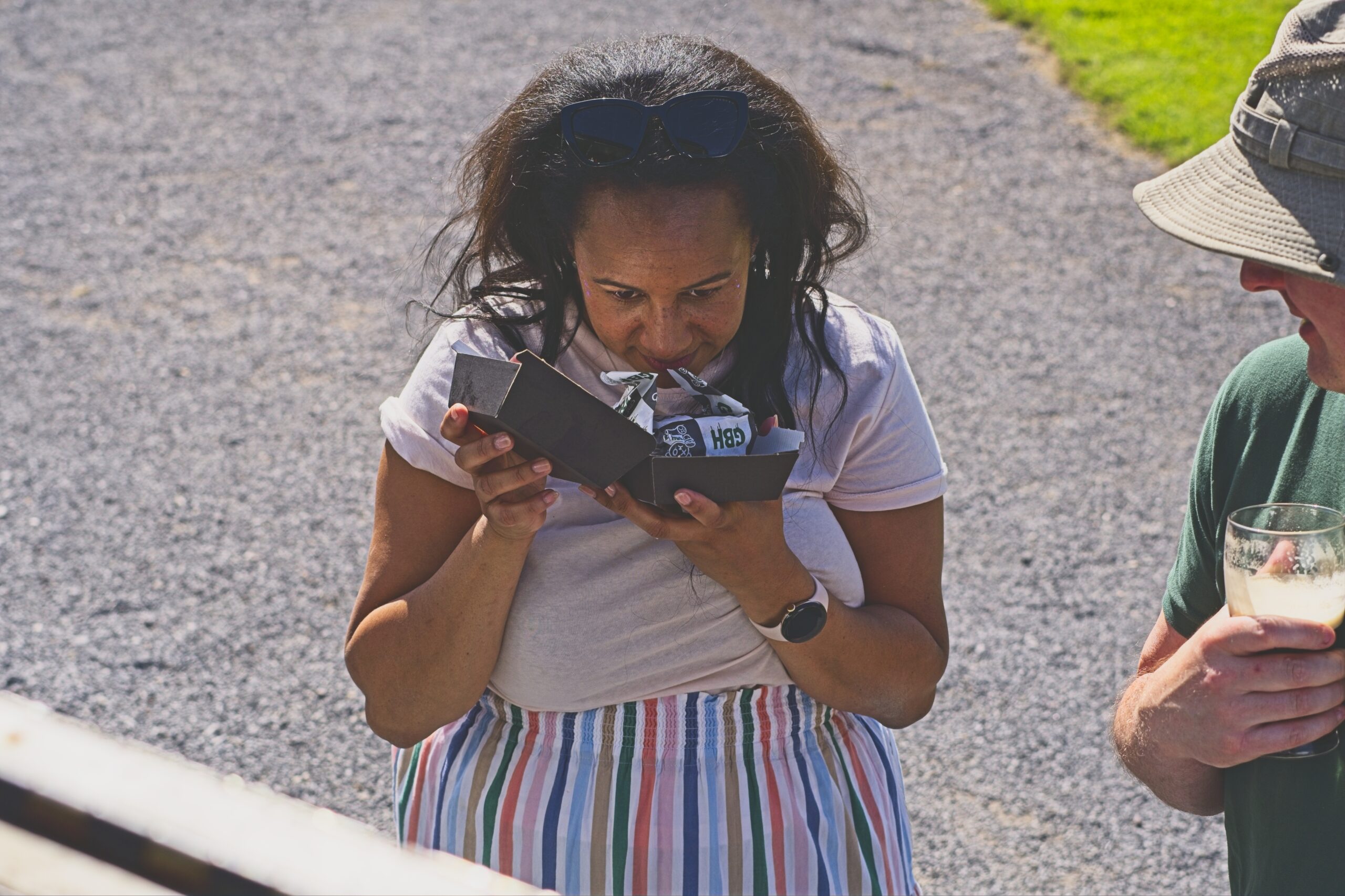 A burger fan sniffing their burger at an event with the GBH truck in Somerset