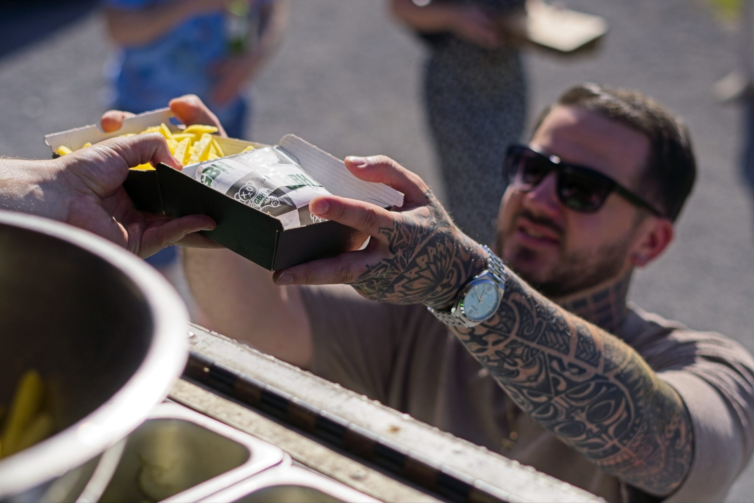 a hungry burger fan grabbing their food at at event near Bristol